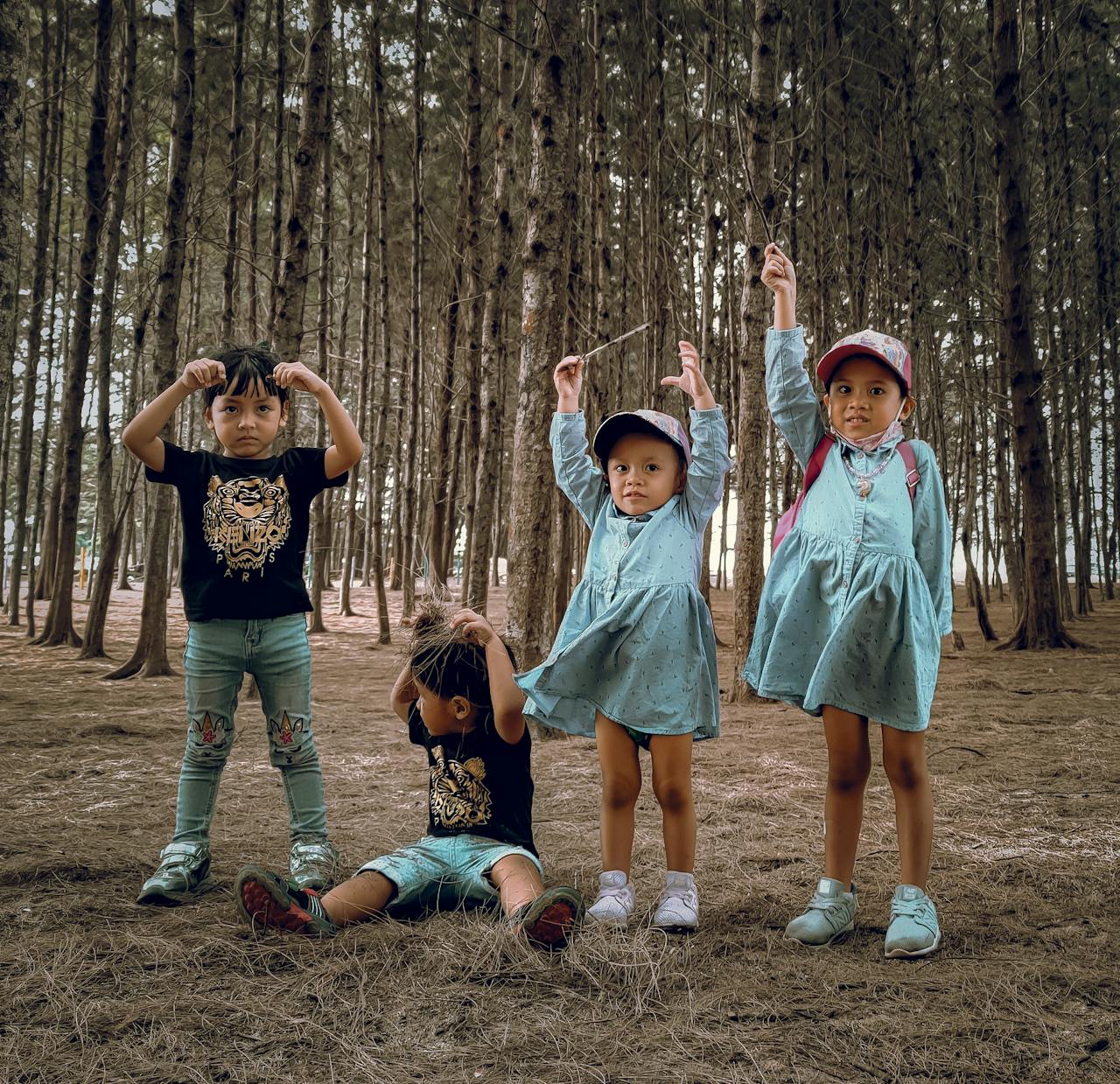 Four children enjoying a playful day in a Kota Bharu, Malaysia forest.