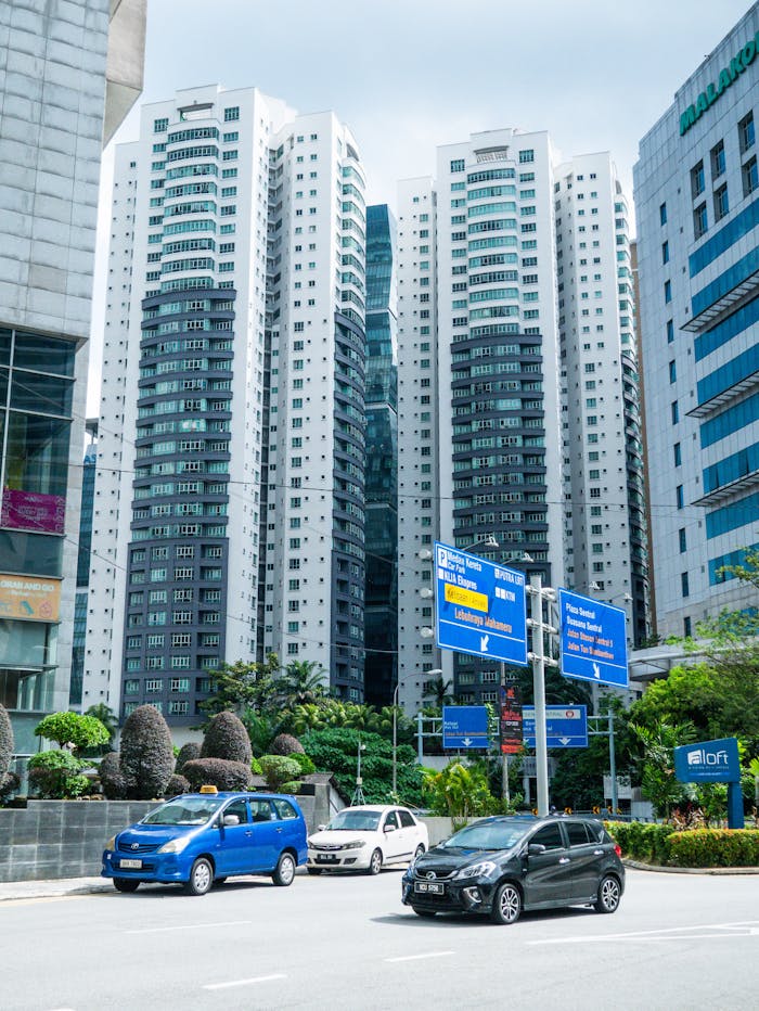 Vibrant city scene in Kuala Lumpur featuring tall skyscrapers and busy traffic.
