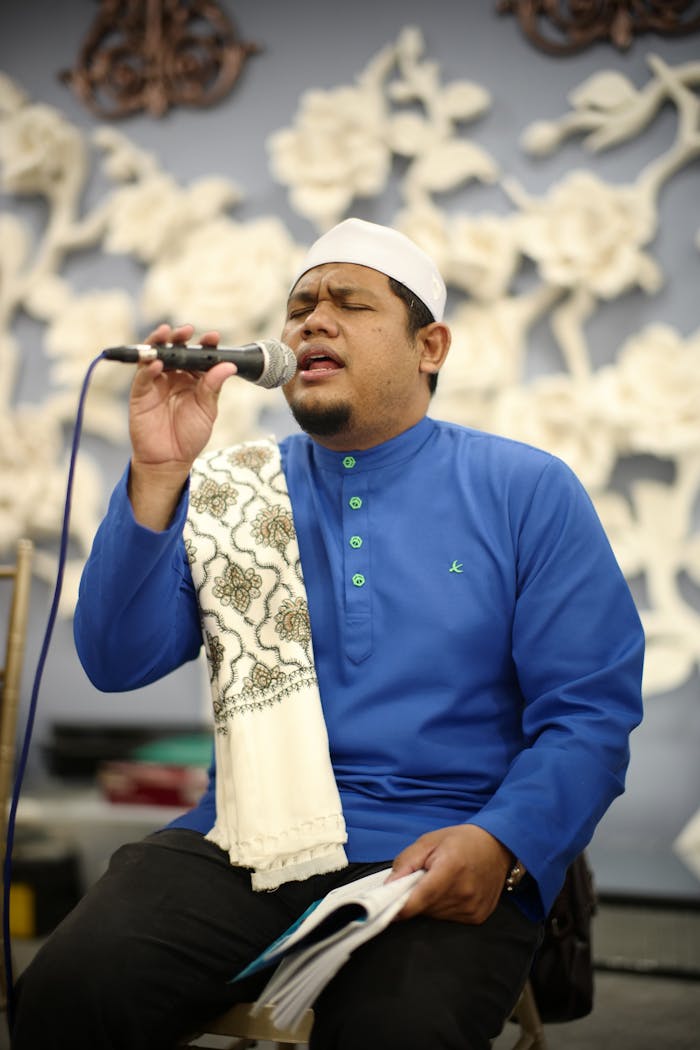 Portrait of a Muslim man singing passionately indoors in Kuala Lumpur, Malaysia