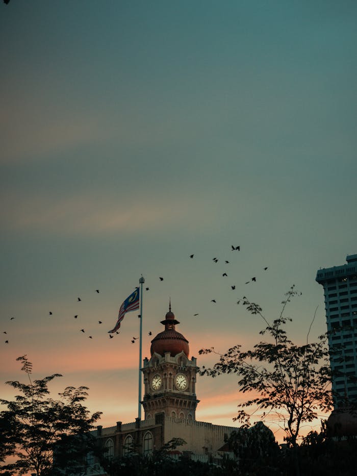 pexels-photo-2389473 Majestic view of Sultan Abdul Samad Building's clock tower at sunset in Kuala Lumpur, Malaysia.